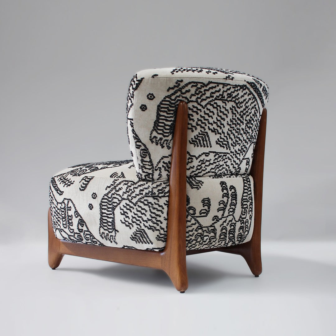 Black and white abstract pattern armchair with wooden legs, showcasing a modern and minimalist design.