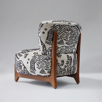 Black and white abstract pattern armchair with wooden legs, showcasing a modern and minimalist design.