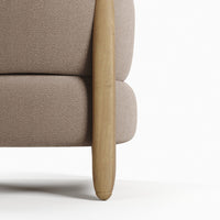 Beige upholstered sofa with a smooth wooden leg, featuring a minimalist design and soft texture.