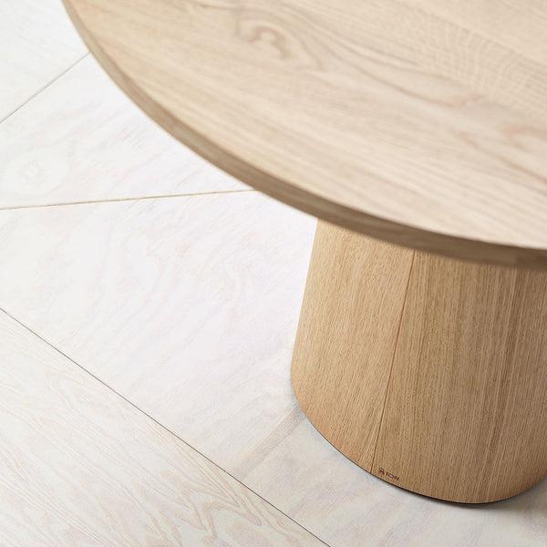 Natural wood table with light beige tones and soft grain patterns, showcasing minimalist design and elegant texture.