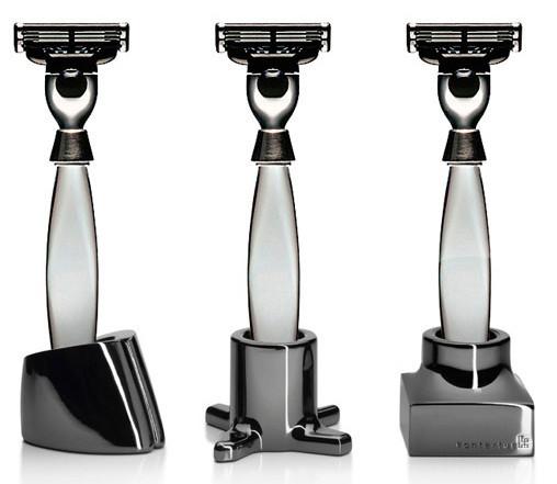 Three sleek, modern razors with polished silver and black accents, featuring unique base designs and stylish patterns.