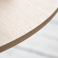 Light oak table edge with a smooth, textured finish and subtle wood grain pattern. Neutral tones enhance modern decor.