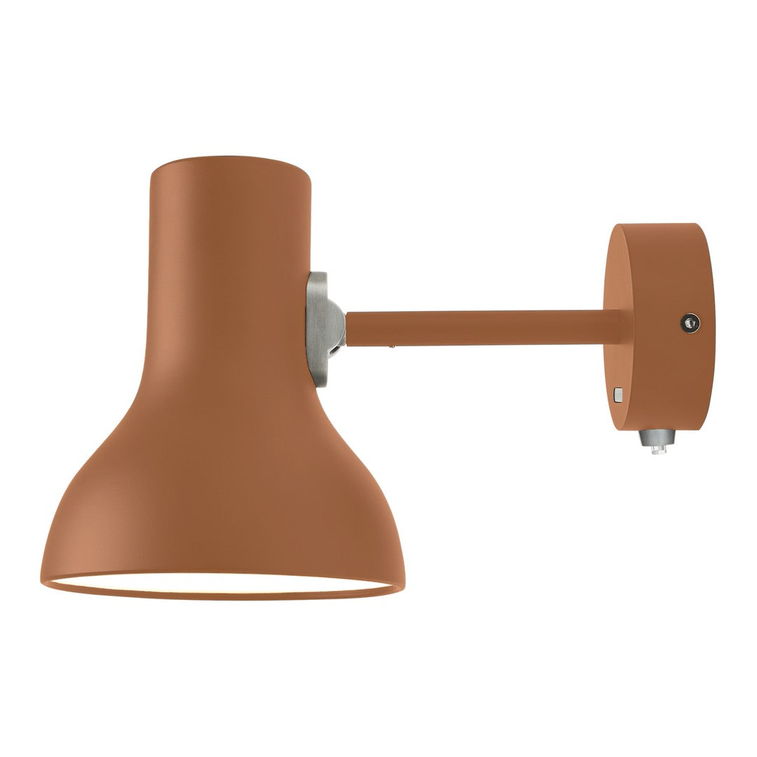 Terra cotta wall lamp with a sleek modern design and smooth matte finish, perfect for stylish indoor lighting.