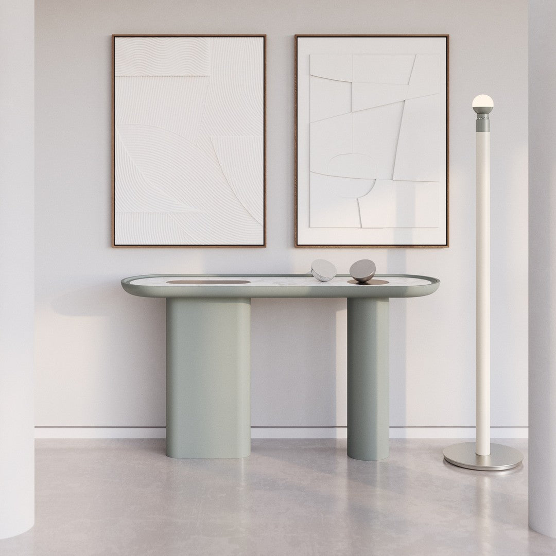Stylish light green console table with smooth curves, complemented by minimalist artwork in neutral tones.