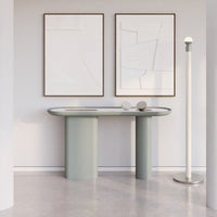 Stylish light green console table with smooth curves, complemented by minimalist artwork in neutral tones.