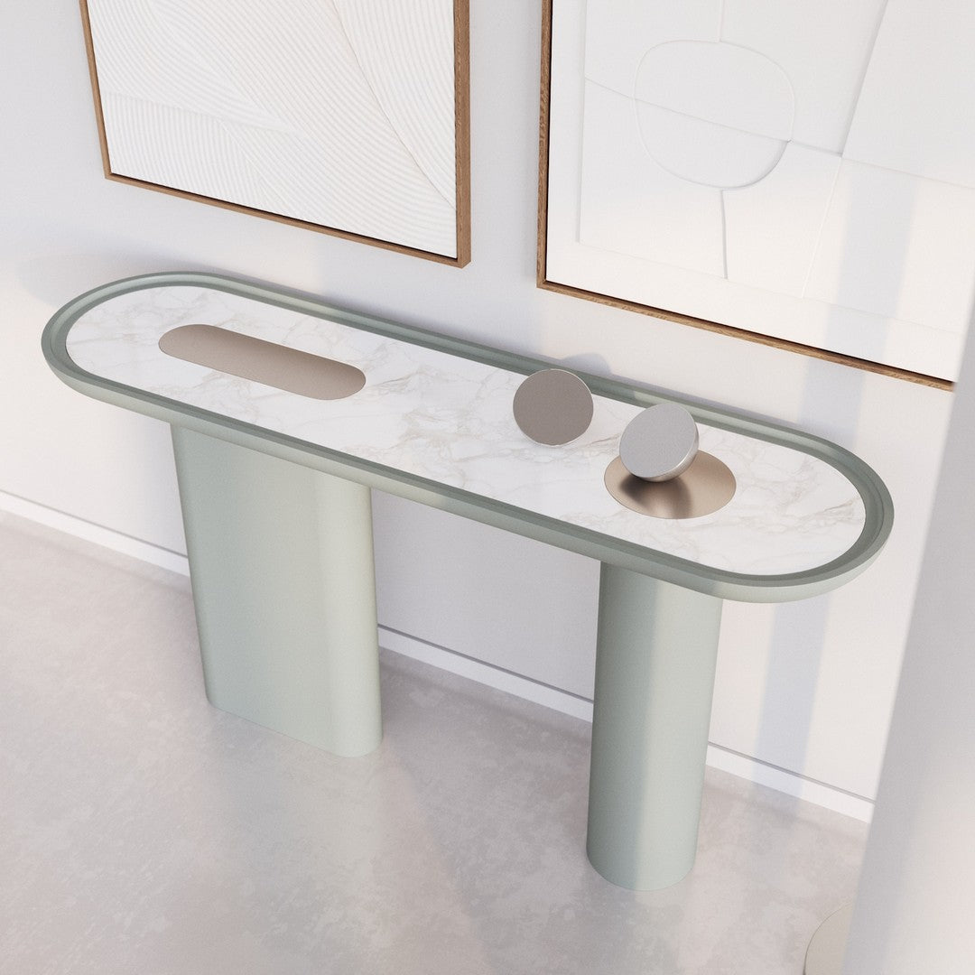 Modern oval console table with a soft green finish and marble-patterned top, featuring smooth, rounded edges.