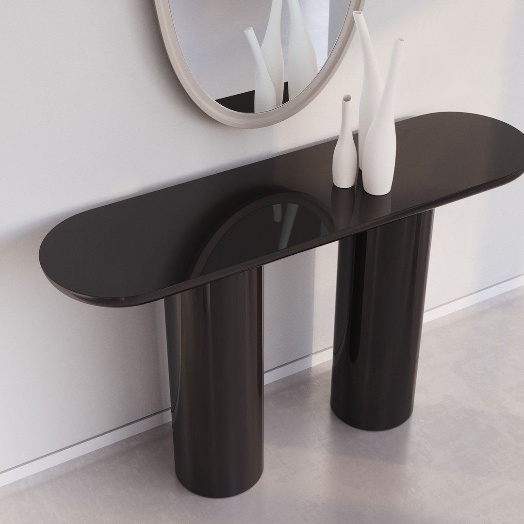 Sleek black console table with glossy finish and cylindrical legs, complementing minimalist decor.