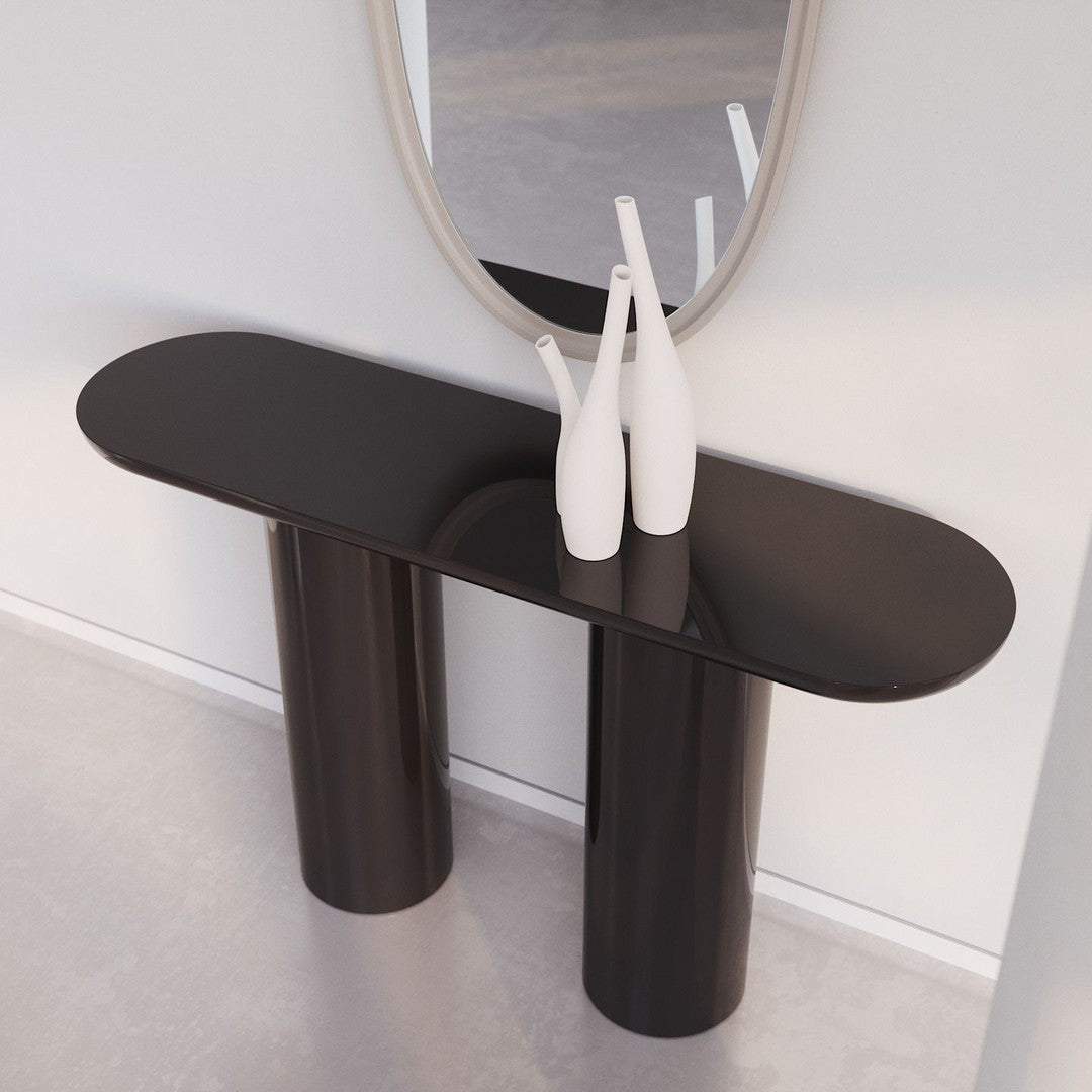 Sleek black console table with smooth, glossy finish, featuring minimalist design and cylindrical legs.