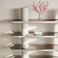 Light beige shelves with smooth curves, adorned with a white vase and red floral accents. Minimalist and modern design.