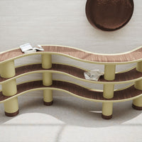 Curvy shelving unit with creamy yellow and rich brown wood tones, featuring a modern wave pattern.