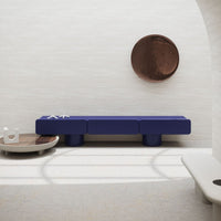 Navy blue modern coffee table with clean lines, paired with earthy tones and smooth surfaces in a minimalist setting.