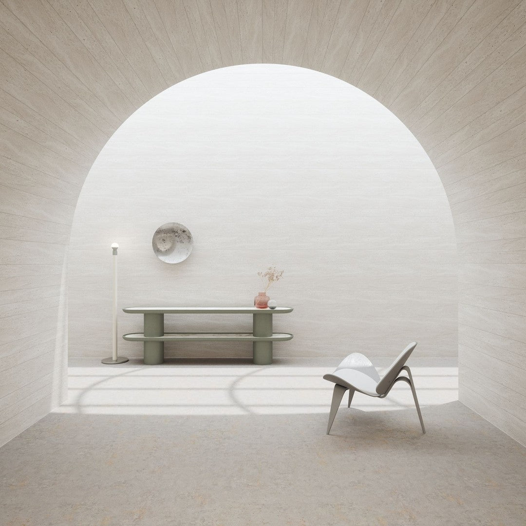 Minimalist interior with soft beige walls, a light green table, and a patterned floor, creating a serene color palette.