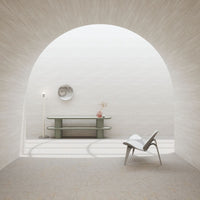 Minimalist interior with soft beige walls, a light green table, and a patterned floor, creating a serene color palette.