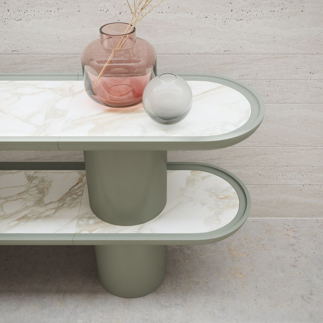 Green and white marble tabletop with soft curves, featuring a textured grey base and decorative glass vases.
