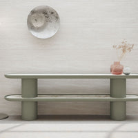 Modern green console table with a smooth finish, featuring curved edges and minimalist design against a neutral backdrop.
