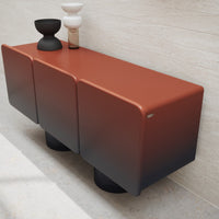 Modern three-drawer console in rust orange with gradient black accents, featuring a sleek, matte finish.