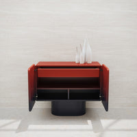 Modern red and black cabinet with sleek lines and glossy finishes, featuring open storage compartments.