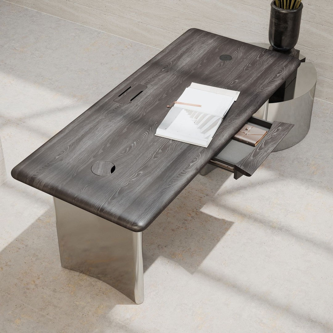 Sleek gray wood desk with a polished silver base, featuring a modern design and subtle surface texture.