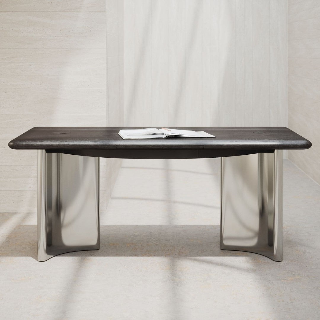 Sleek dark wood tabletop with smooth silver metal legs against a light, textured background. Modern minimalist design.