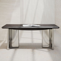 Sleek dark wood tabletop with smooth silver metal legs against a light, textured background. Modern minimalist design.