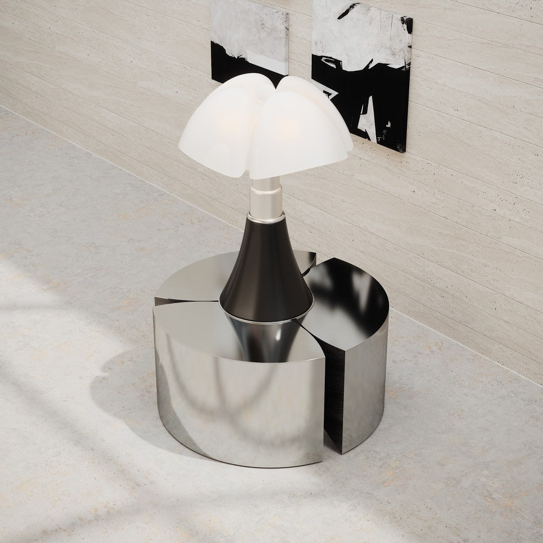 Modern lamp with a sleek black base and white glass shades, featuring a reflective chrome circular stand.