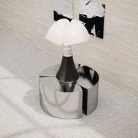 Modern lamp with a sleek black base and white glass shades, featuring a reflective chrome circular stand.