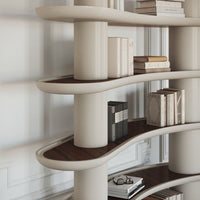 Curved cream shelves with rich brown accents, featuring minimalist book displays and modern design elements.