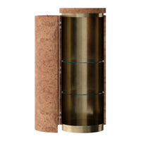 Round display cabinet with textured cork exterior, brass accents, and clear glass shelves. Earthy and modern color palette.