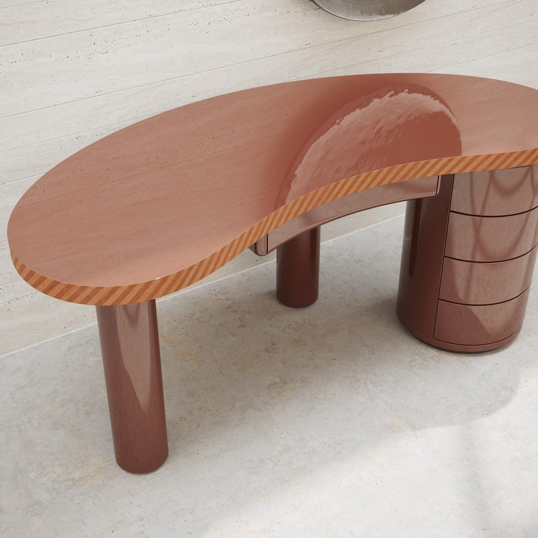 Curved brown desk with glossy finish and striped edge detail, featuring cylindrical legs for a modern look.