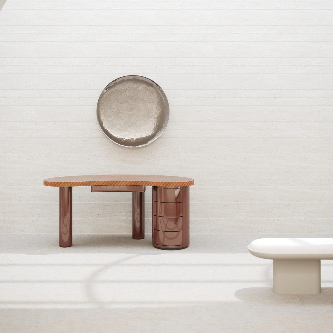Modern curved wooden table in warm brown tones, paired with a minimalist white bench and a circular metallic wall decor.