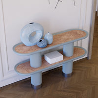 Light blue decorative shelf with rounded edges and a cork top, featuring smooth shapes and subtle textures.