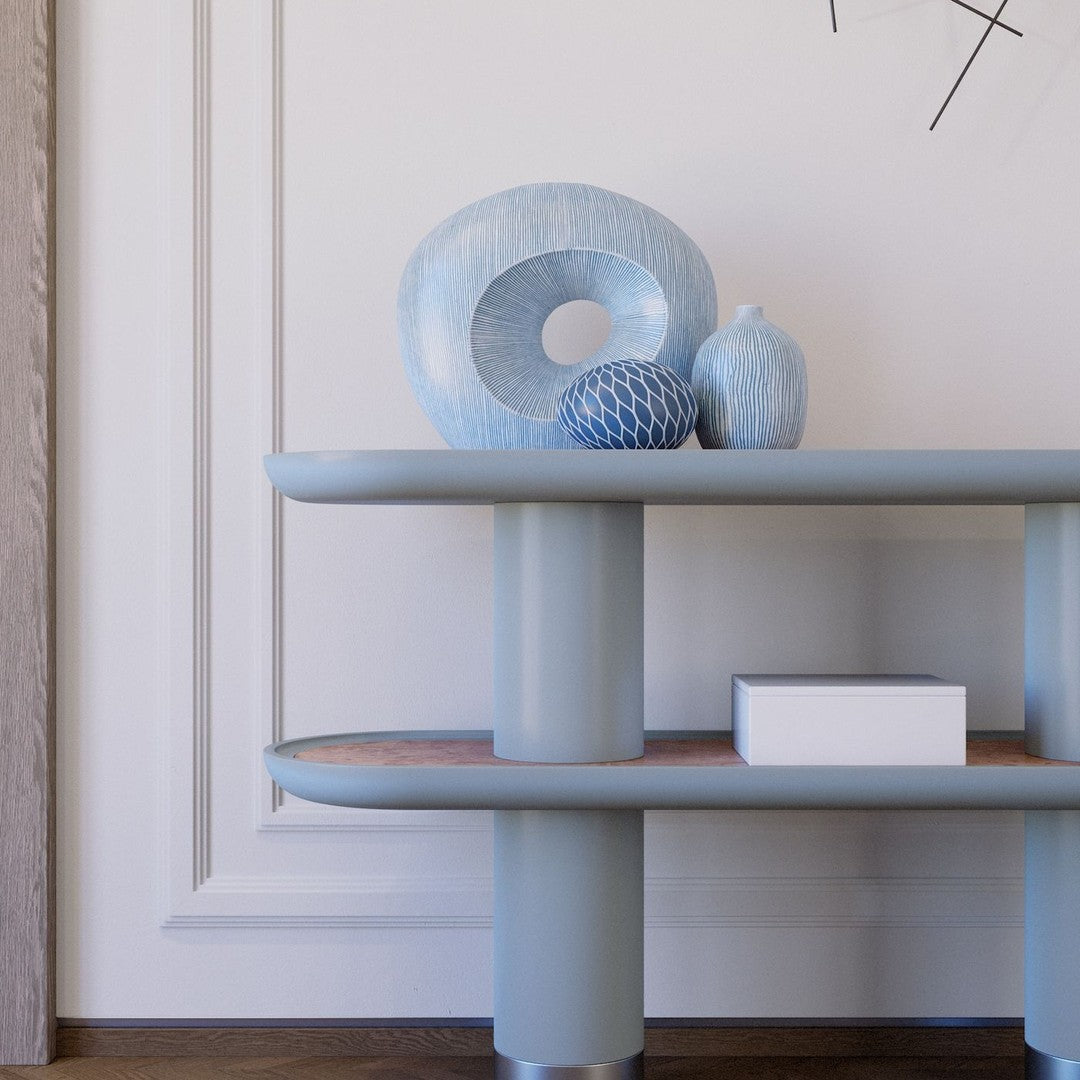 Blue ceramics on a light blue shelf, featuring textured patterns and subtle earthy accents.