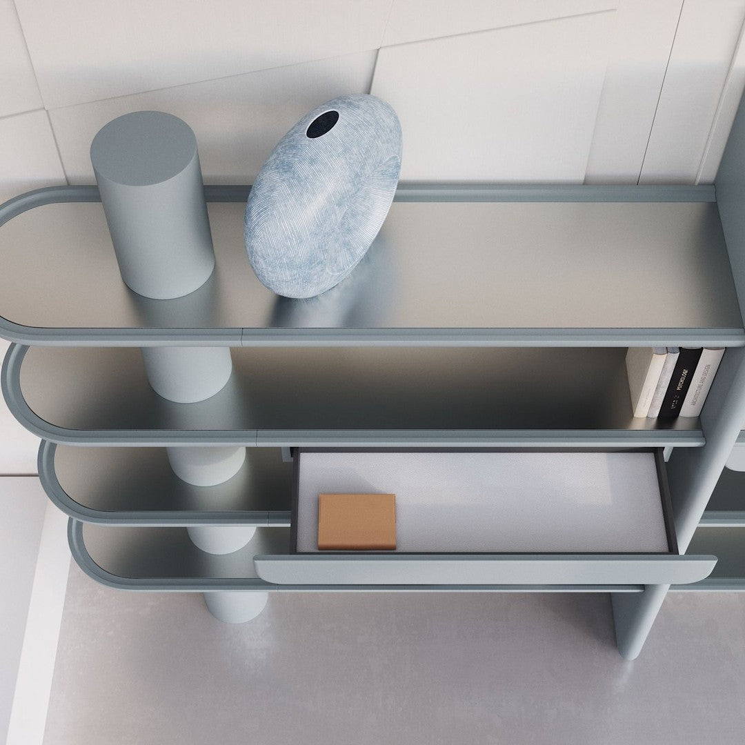 Contemporary light blue shelving unit with smooth curves and a minimalist design, featuring reflective surfaces and subtle patterns.