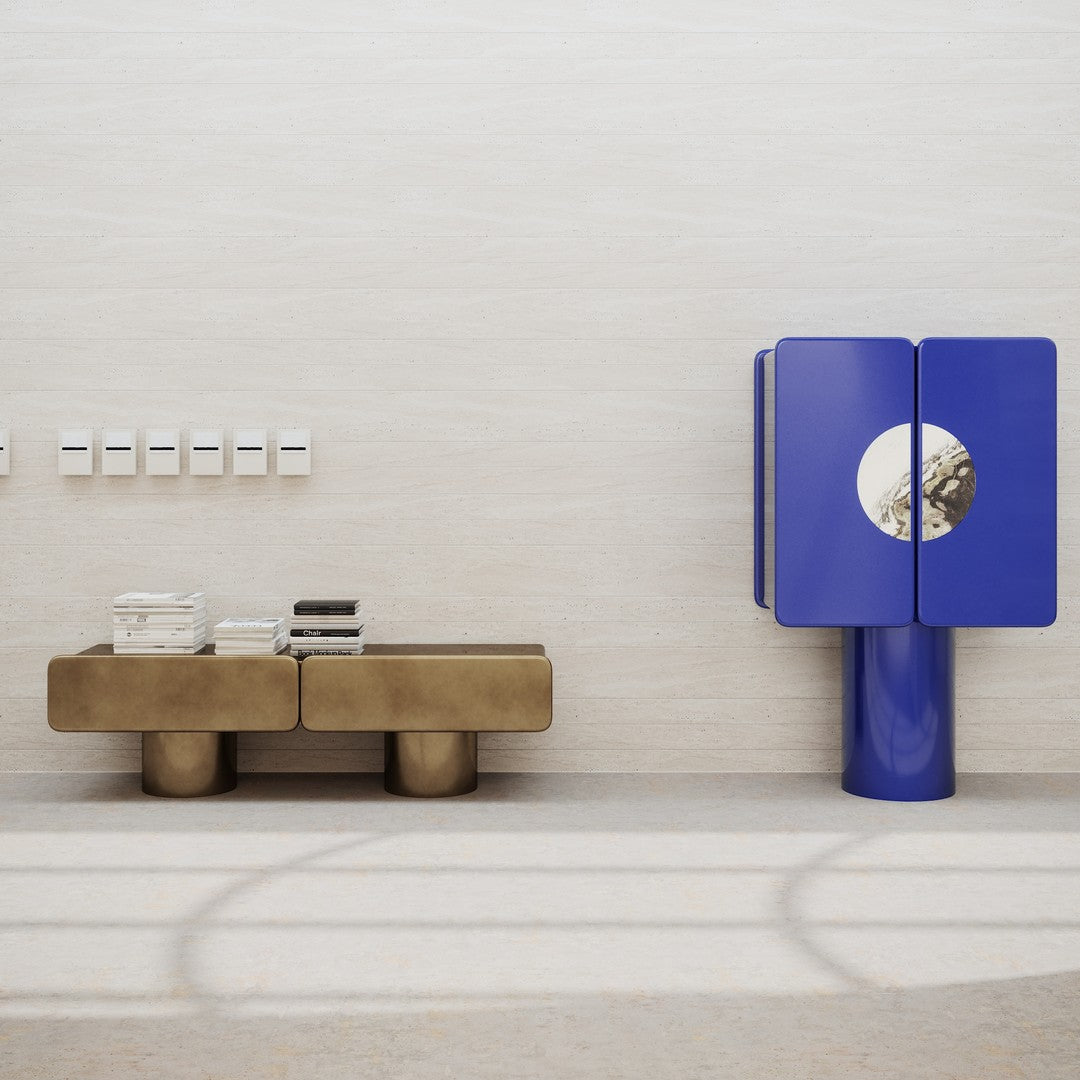 "Modern furniture in metallic gold and vibrant blue with sleek lines and geometric patterns against a neutral background."