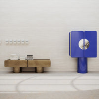 "Modern furniture in metallic gold and vibrant blue with sleek lines and geometric patterns against a neutral background."