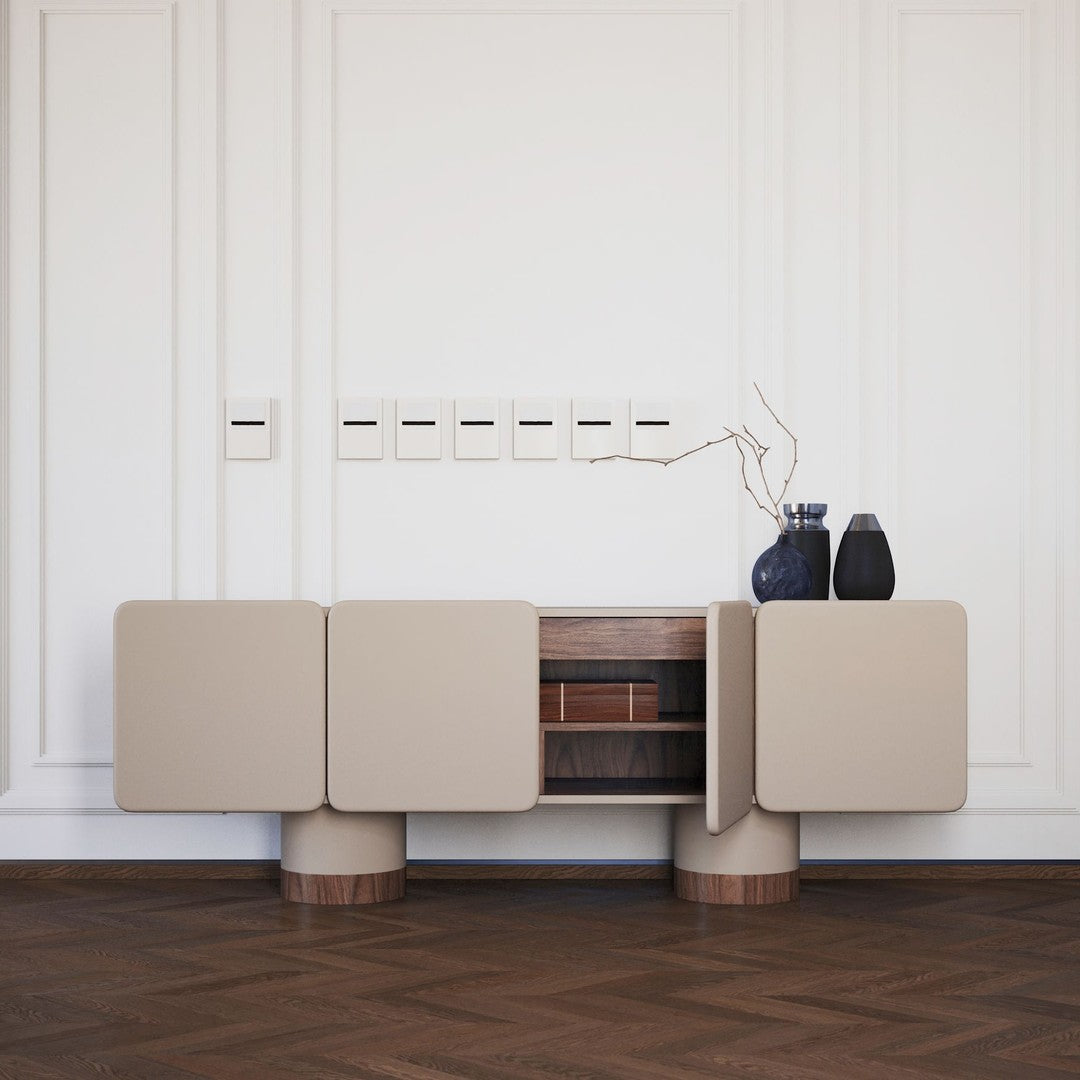 Beige sideboard with wooden accents, featuring minimalistic design and smooth surfaces on a hardwood floor.