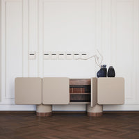 Beige sideboard with wooden accents, featuring minimalistic design and smooth surfaces on a hardwood floor.