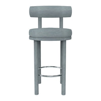 Gray upholstered bar stool with a minimalistic design and smooth fabric finish. Elegant chrome footrest adds a modern touch.