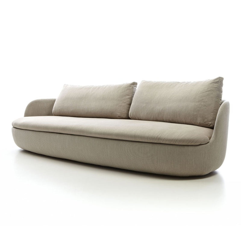Beige modern sofa with soft, curved lines and plush cushions, featuring a minimalist design and smooth fabric texture.
