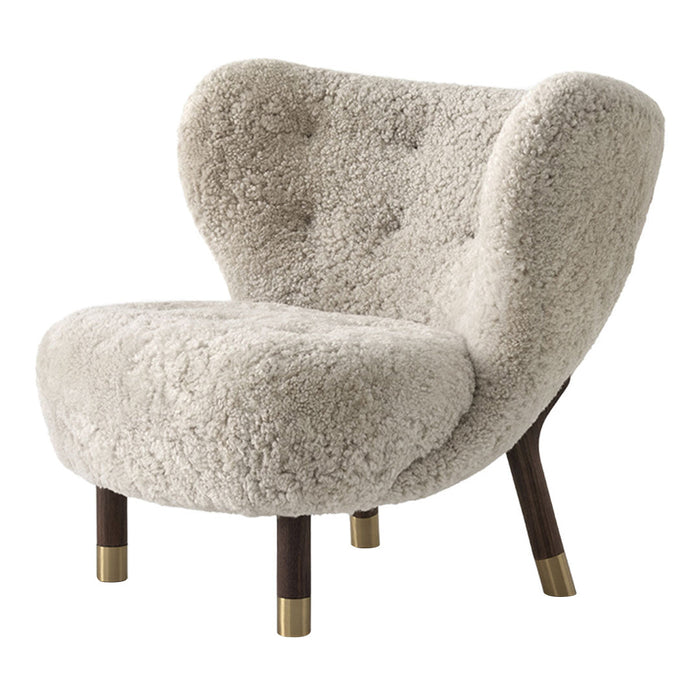 Cozy cream faux fur armchair with a rounded design and natural wood legs featuring gold accents. Perfect for modern decor.