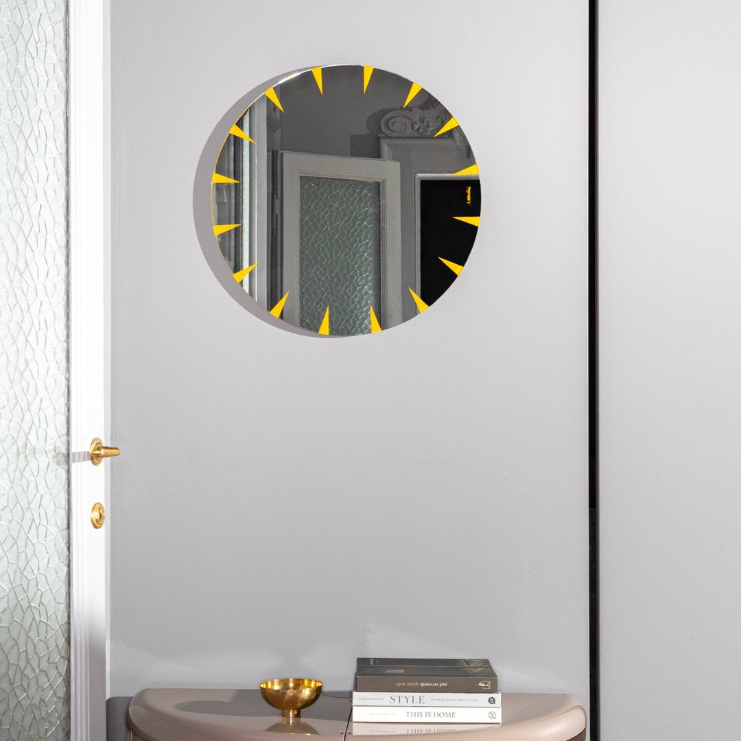 Round mirror with a sleek gray frame and vibrant yellow sunburst design, perfect for modern decor.