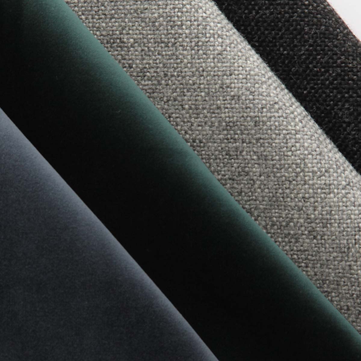 Textured fabric swatches in black, gray, dark green, and deep blue hues, showcasing rich colors and patterns.