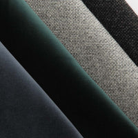 Textured fabric swatches in black, gray, dark green, and deep blue hues, showcasing rich colors and patterns.