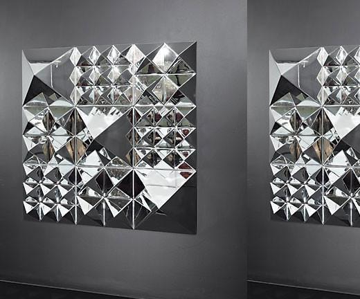 Stylish geometric mirror wall art featuring a mix of silver and reflective surfaces, creating a dynamic visual pattern.
