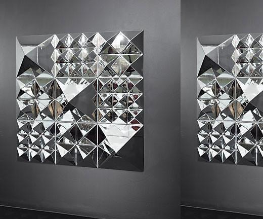 Mirrored wall art featuring geometric silver and chrome patterns for a modern decor accent.