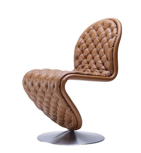 Brown tufted leather chair with a sleek design and modern chrome base, showcasing a unique curvy silhouette.