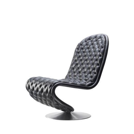 Stylish black tufted lounge chair with a modern design and sleek curves, perfect for contemporary interiors.