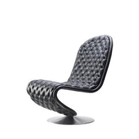 Stylish black tufted lounge chair with a modern design and sleek curves, perfect for contemporary interiors.