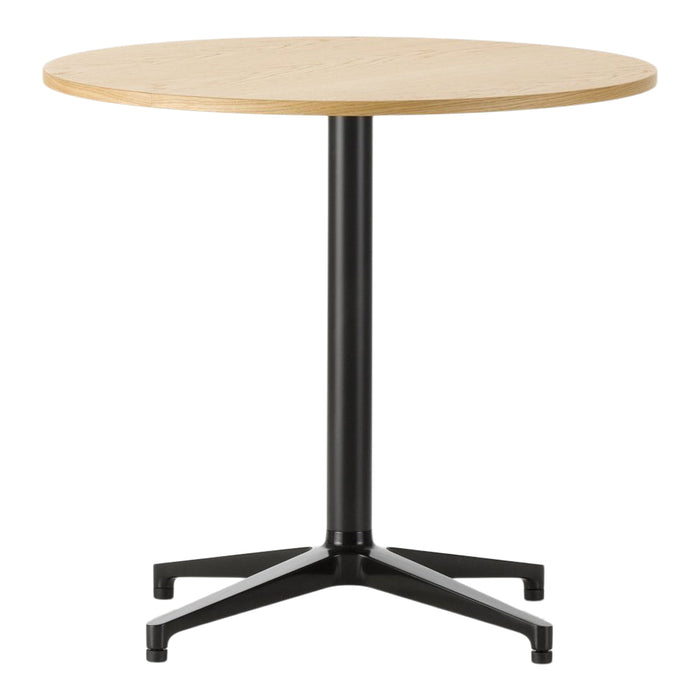 Round wooden table with a natural light wood finish and a sleek black metal base. Simple, modern design.