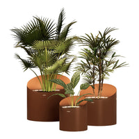 Set of three round planters in earthy brown hues, featuring lush green tropical plants, creating a vibrant, natural aesthetic.